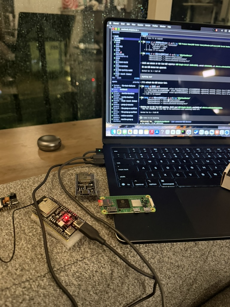 The bench on night one: laptop open, Herald's board wired beside it