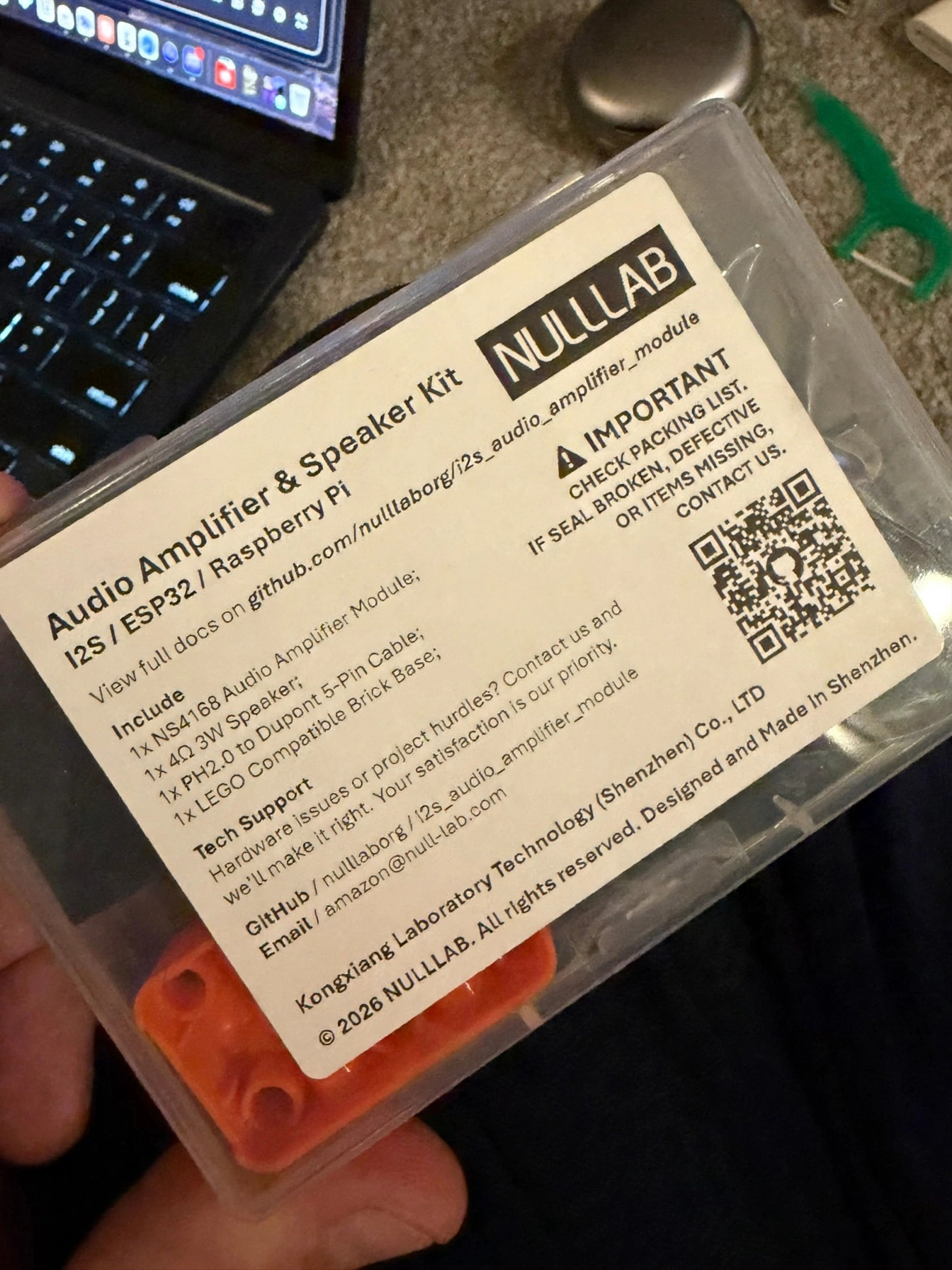 The NULLLAB audio amplifier and speaker kit box, held in hand, label readable